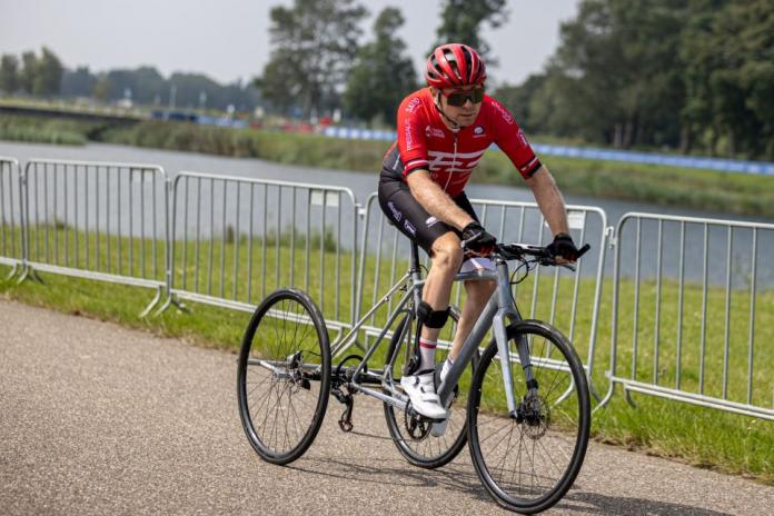 Martin Heggelund riding an adaptive bike with three wheels