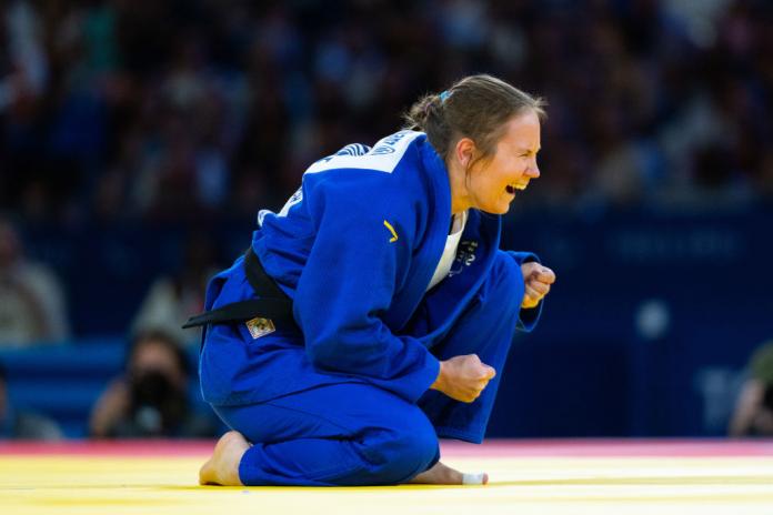 Nicolina Pernhaeim Goodrich reacts to a win on the mat
