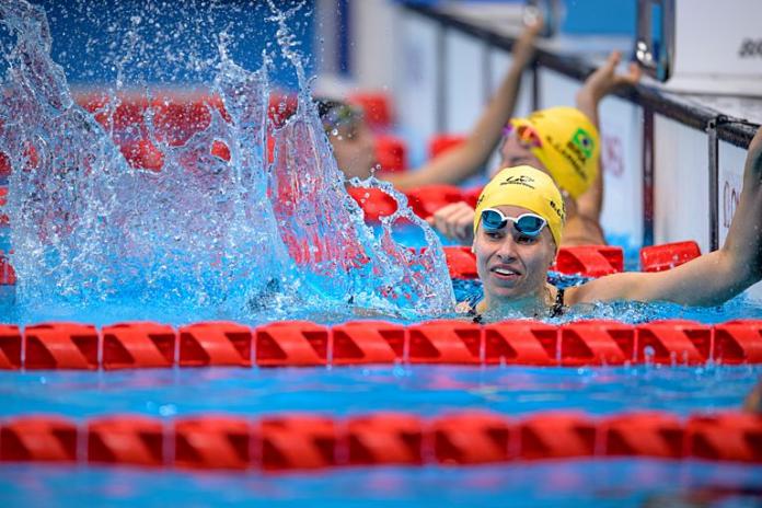 Debora and Beatriz Borges Carneiro splash water in celebration