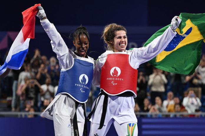  Ana Carolina Silva de Moura of Team Brazil celebrates with Djelika Diallo of Team France after their Women K44 -65kg Gold Medal final on day two of the Paris 2024 Summer Paralympic Games at Grand Palais on August 30, 2024 in Paris, France.