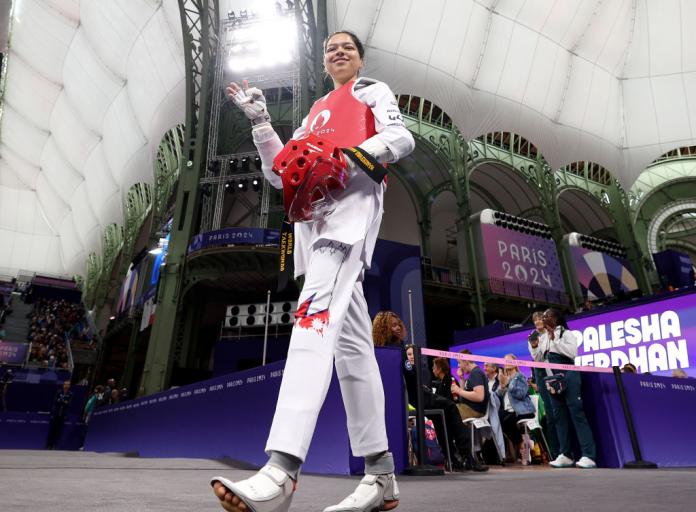 A female Para taekwondo athlete steps into the Para taekwondo arena