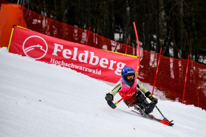 A female Para alpine sit skier is in action