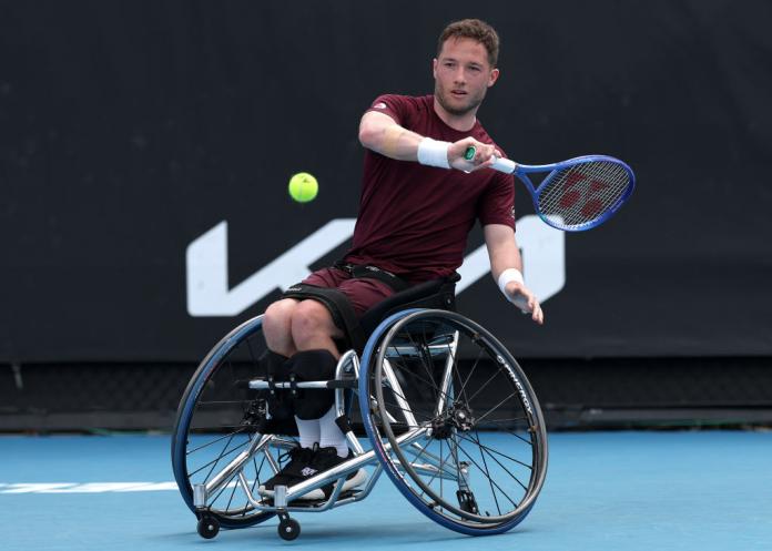 A male wheelchair tennis player in action
