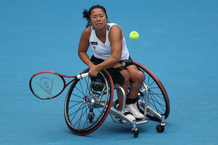 A female wheelchair tennis player in action at the Australian Open