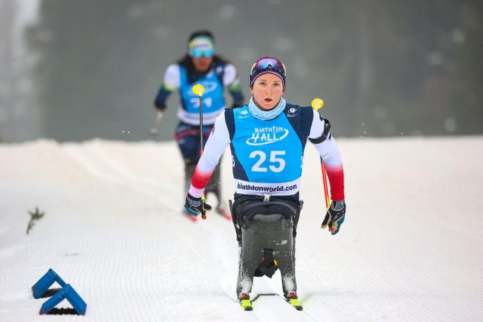 A female Para biathlon athlete competes in a sit-ski