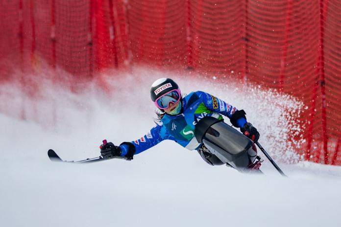 A female Para alpine sit skier is in action