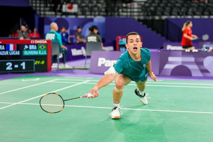 A male Para badminton player reaches in during a Para badminton game