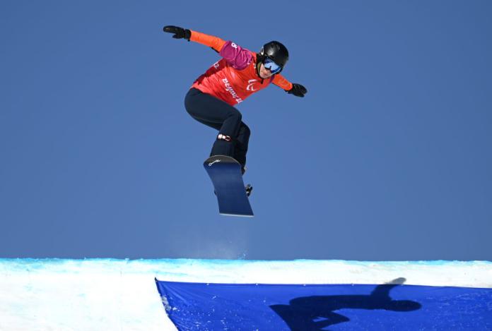 A female Para snowboarding athlete in action