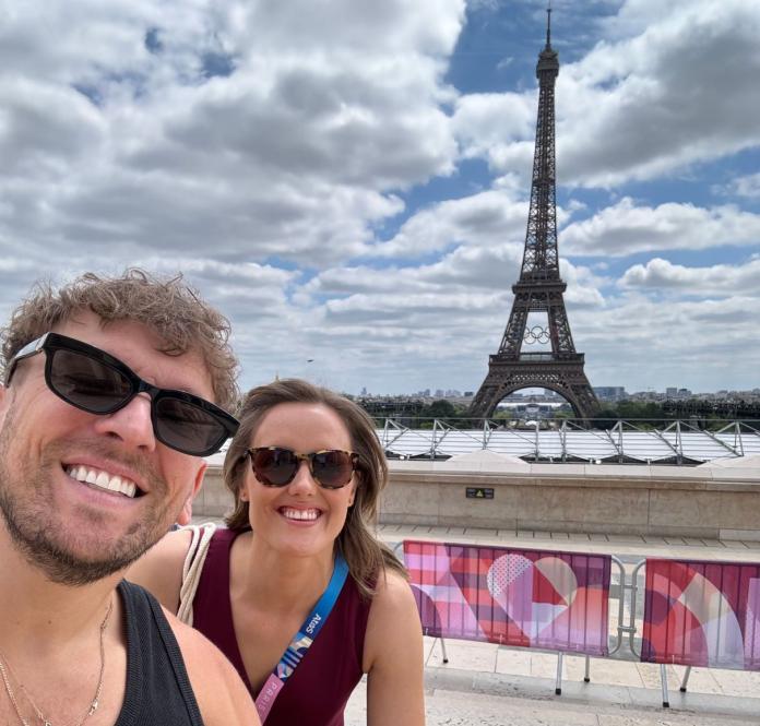 Dylan Alcott and Ellie Cole pose for a selfie in front of the Eiffel Tower during Paris 2024