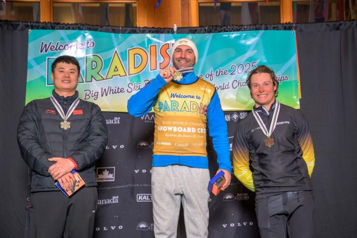 Three male snowboarders on the podium