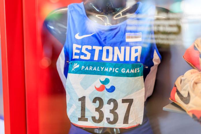 A blue Estonia running jersey with a bib that says Paralympic Games