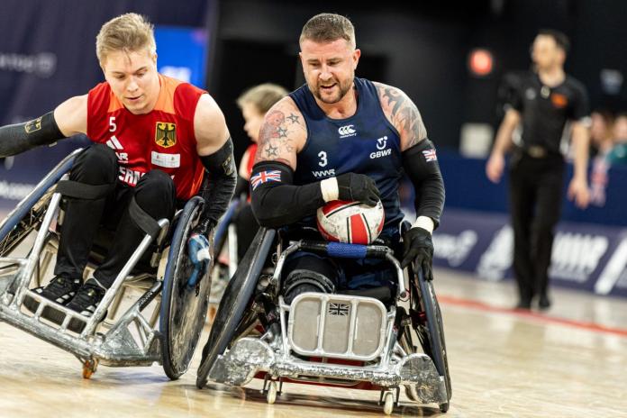 Two male wheelchair rugby athletes in action
