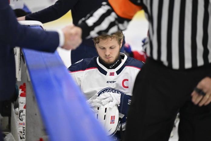 A male Para ice hockey player getting ready for a match