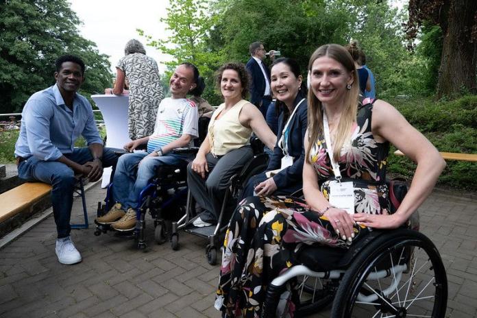 Five people smiling at the camera
