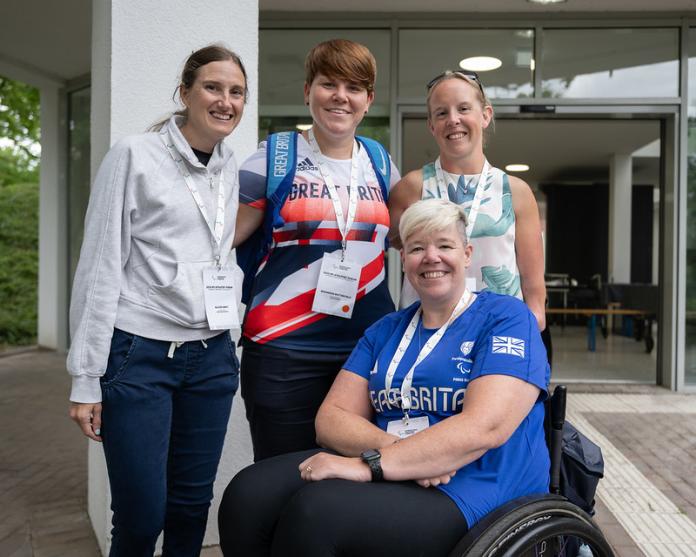 Four athletes posting for a photo