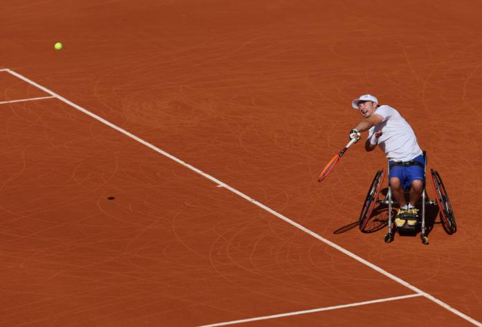 A male wheelchair tennis player in action