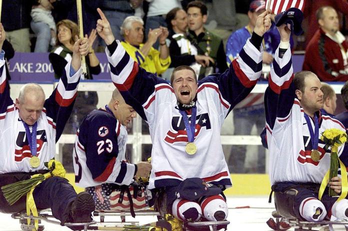 USA Para ice hockey players react on the ice after receiving their medals