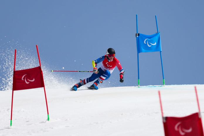 A male Para alpine skier in competition at Beijing 2022