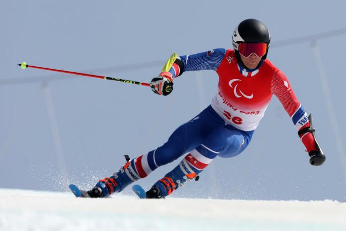 A male Para alpine skier in competition at Beijing 2022