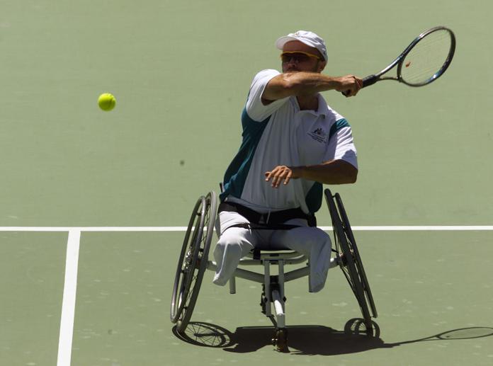 A male wheelchair tennis player in action