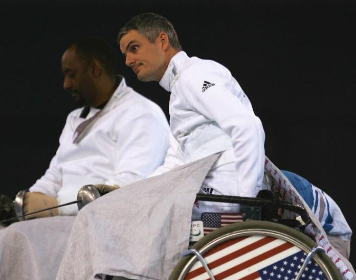 Two male wheelchair fencing athletes during competition at Beijing 2008
