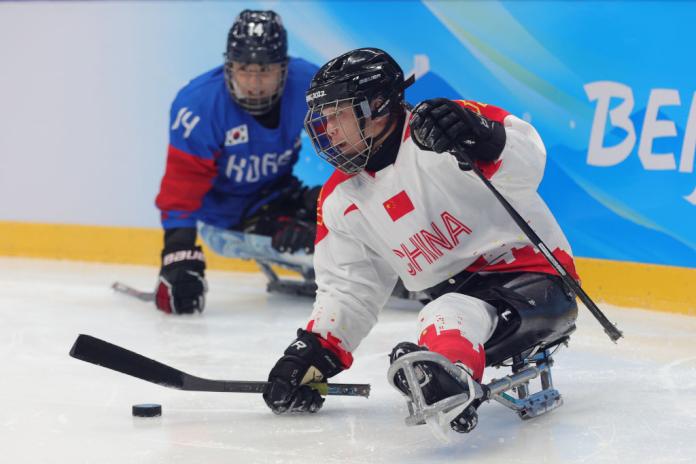 A male Para ice hockey athlete in action at Beijing 2022