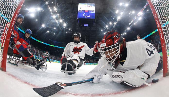A goaltender trying to avoid the puck crossing the goal line