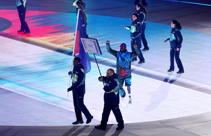 A man raises his arms in the air