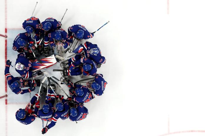 Players of Team United States gather by their goal mouth for a team huddle 