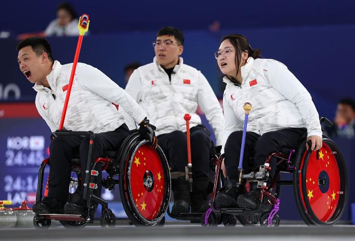 Three wheelchair curling athletes are in competition
