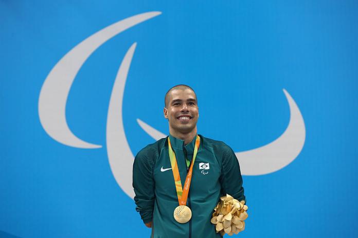 Gold medalist Daniel Dias of Brazil celebrates on the podium at the medal ceremony in the Men's 200m Freestyle - S5 Final on Day 1 of the Rio 2016 Paralympic Games