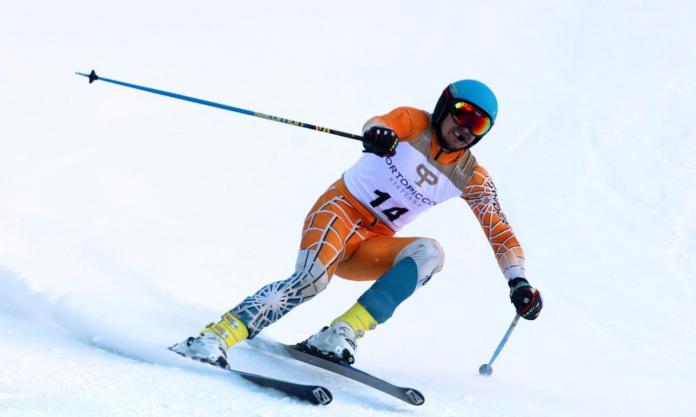 a male vision impaired skier coming down the slope