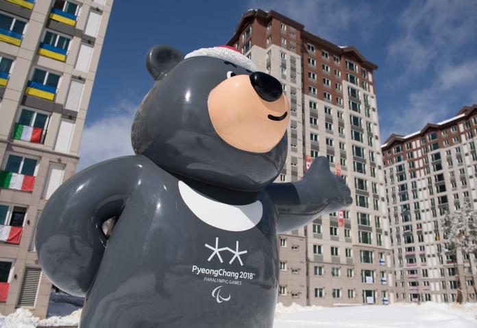 the PyeongChang 2018 mascot stands outside the Athletes' Village