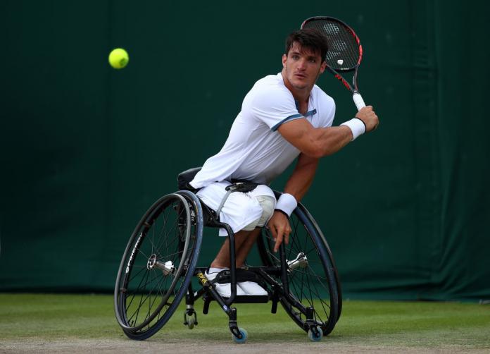 Argentinian male wheelchair tennis player hits a  a backhand shot