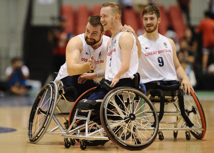 male wheelchair basketball player Gregg Warburton being hugged by a teammate