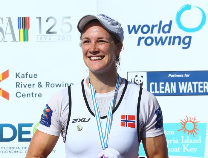 female Para rower Birgit Skarstein smiling with her medal on the podium