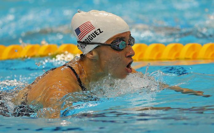 female Para swimmer Ileana Rodriguez takes a breath during a breaststroke