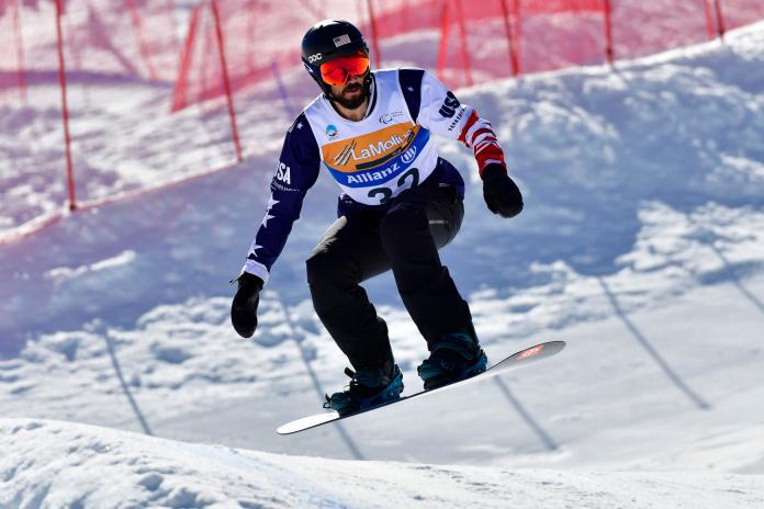 A male Para snowboarder competing