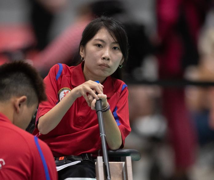 female boccia player Yuen Kei Ho watches a ball being played