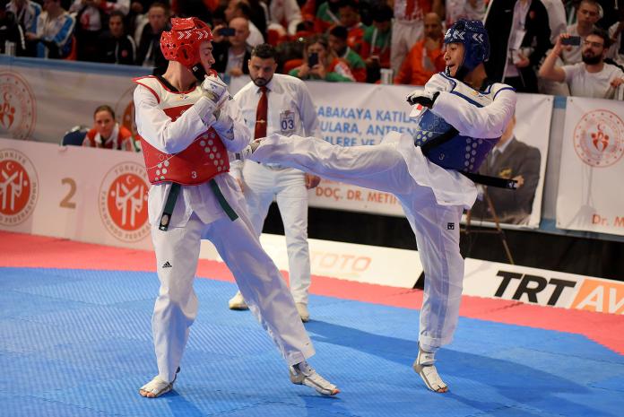 Para taekwondo fighter Juan Diego Garcia Lopez kicks another fighter in the chest