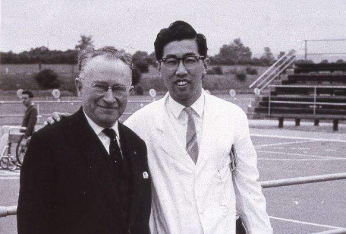 Black and white photo of Japanese man posing with Sir Ludwig Guttman 