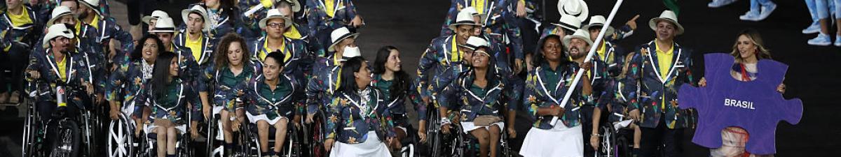 a group of Para athletes walking at an opening ceremony