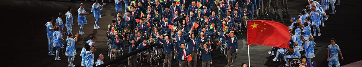 a group of Para athletes walking at an opening ceremony