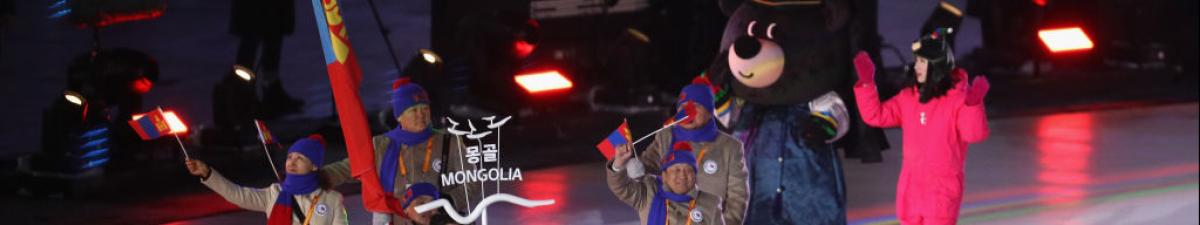 a group of Para athletes walking at an opening ceremony