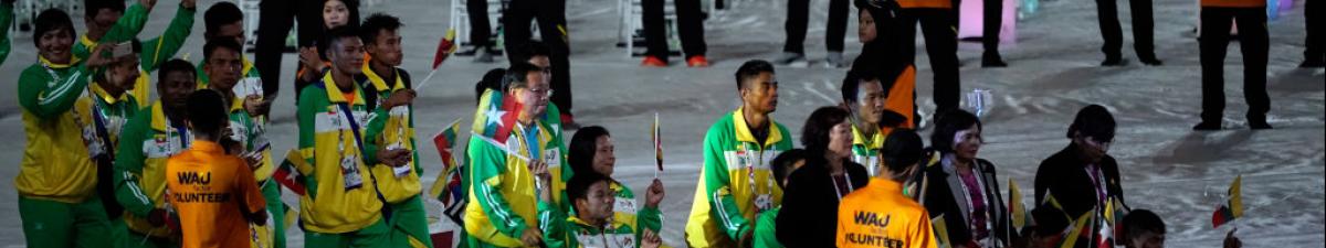 a group of Para athletes walking at an opening ceremony