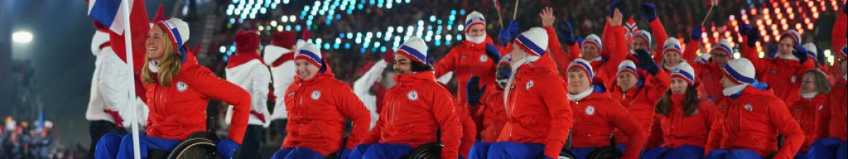 a group of Para athletes walking at an opening ceremony