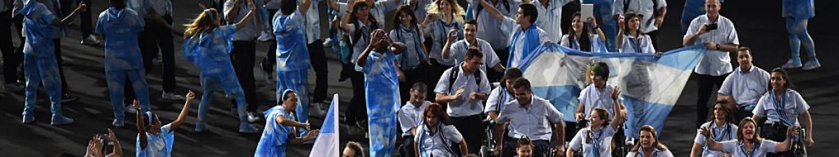 a group of Para athletes walking at an opening ceremony