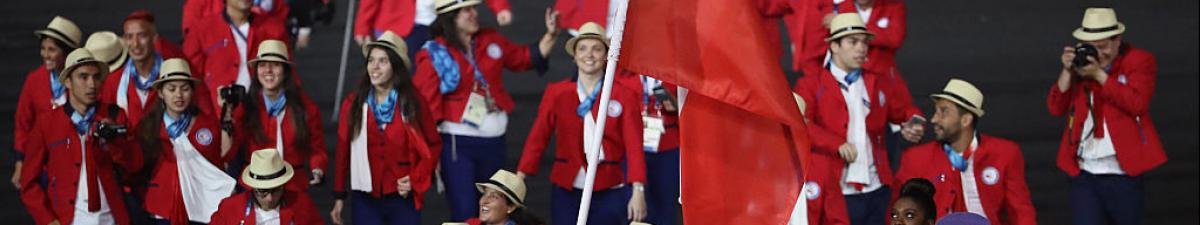 a group of Para athletes walking at an opening ceremony