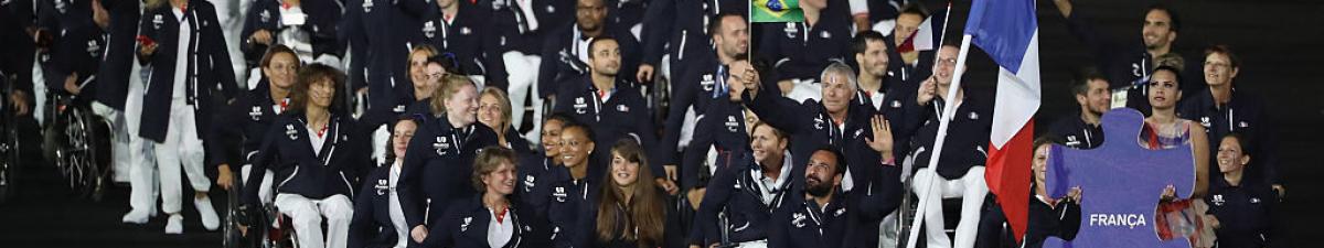 a group of Para athletes walking at an opening ceremony