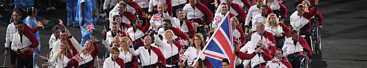 a group of Para athletes walking at an opening ceremony